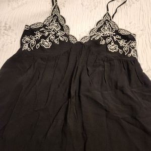 A really cute black flowy top with adorable detail on top